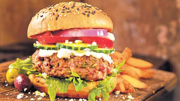 Juicy vegan burger with avocado and lettuce on a toasted bun